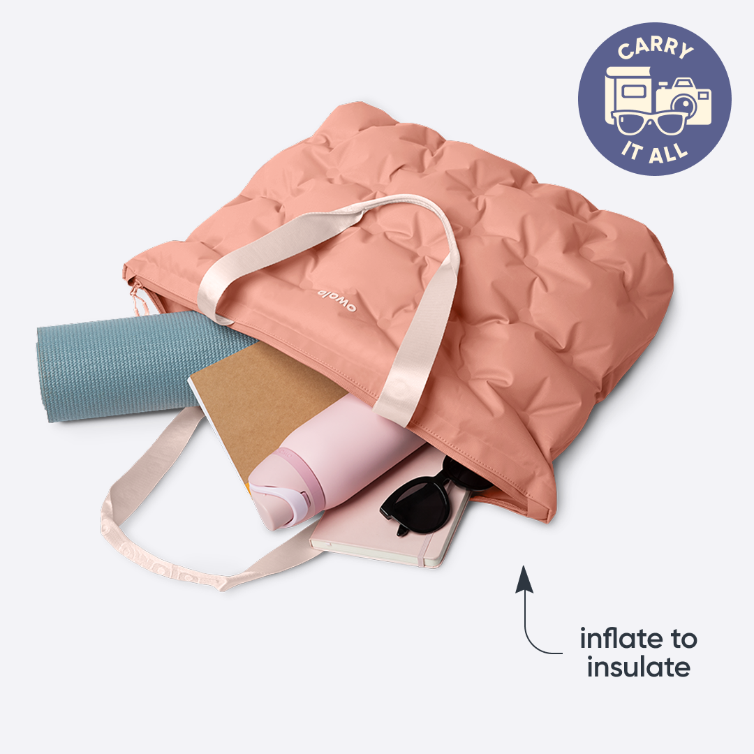Owala Cloud tote in Rosewood, dusty pink inflated tote carrying a yoga mat, notebook, water bottle, and small pouch, with badge reading "CARRY IT ALL" and text overlay reading "inflate to insulate"
